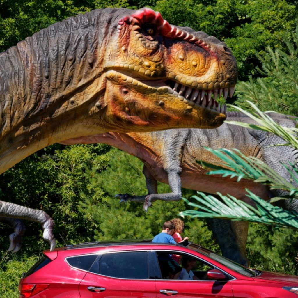 scotty the trex hover over people in a red car